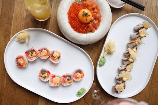 Top-down view of diverse sushi platters featuring salmon roe, rolls, and fresh ingredients.