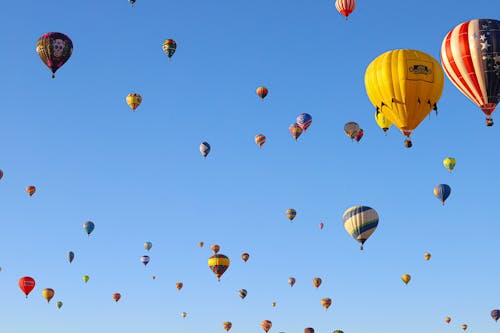 Free Colorful Hot Air Balloons Soaring Under Blue Sky Stock Photo