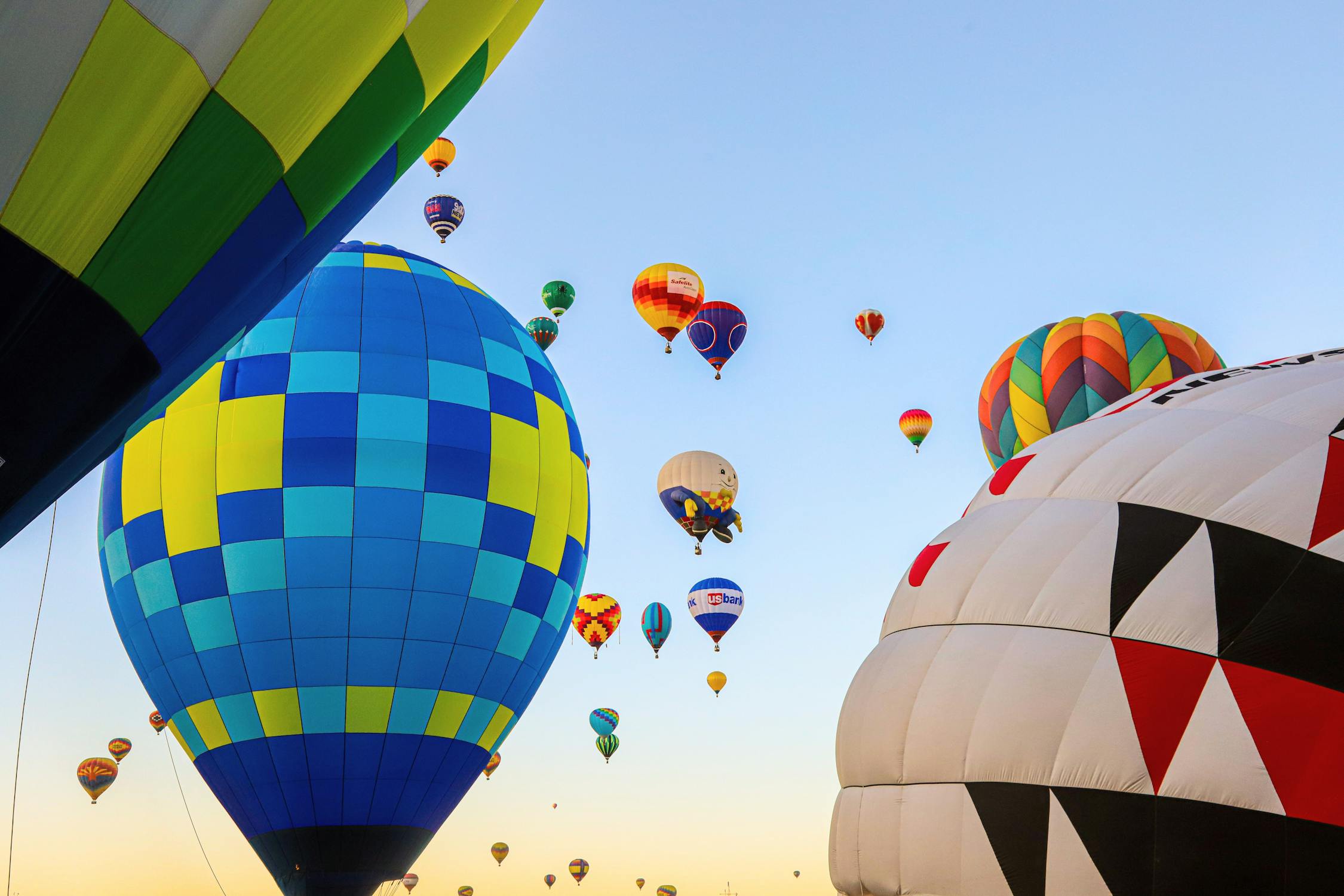 A low-angle photo of multi-colored hot-air balloons