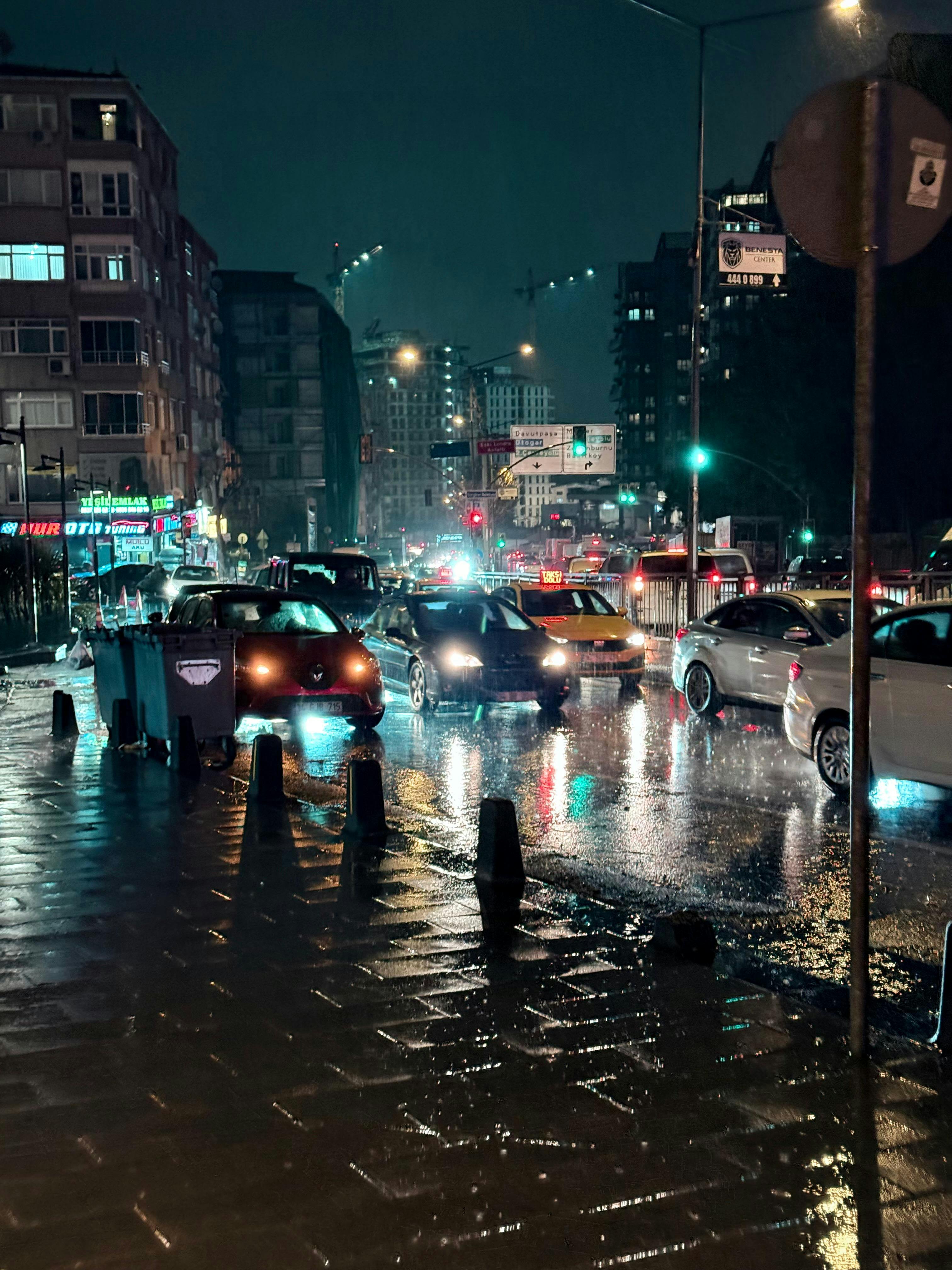 Capture of bustling nighttime traffic on a rainy street in Istanbul, Türkiye.