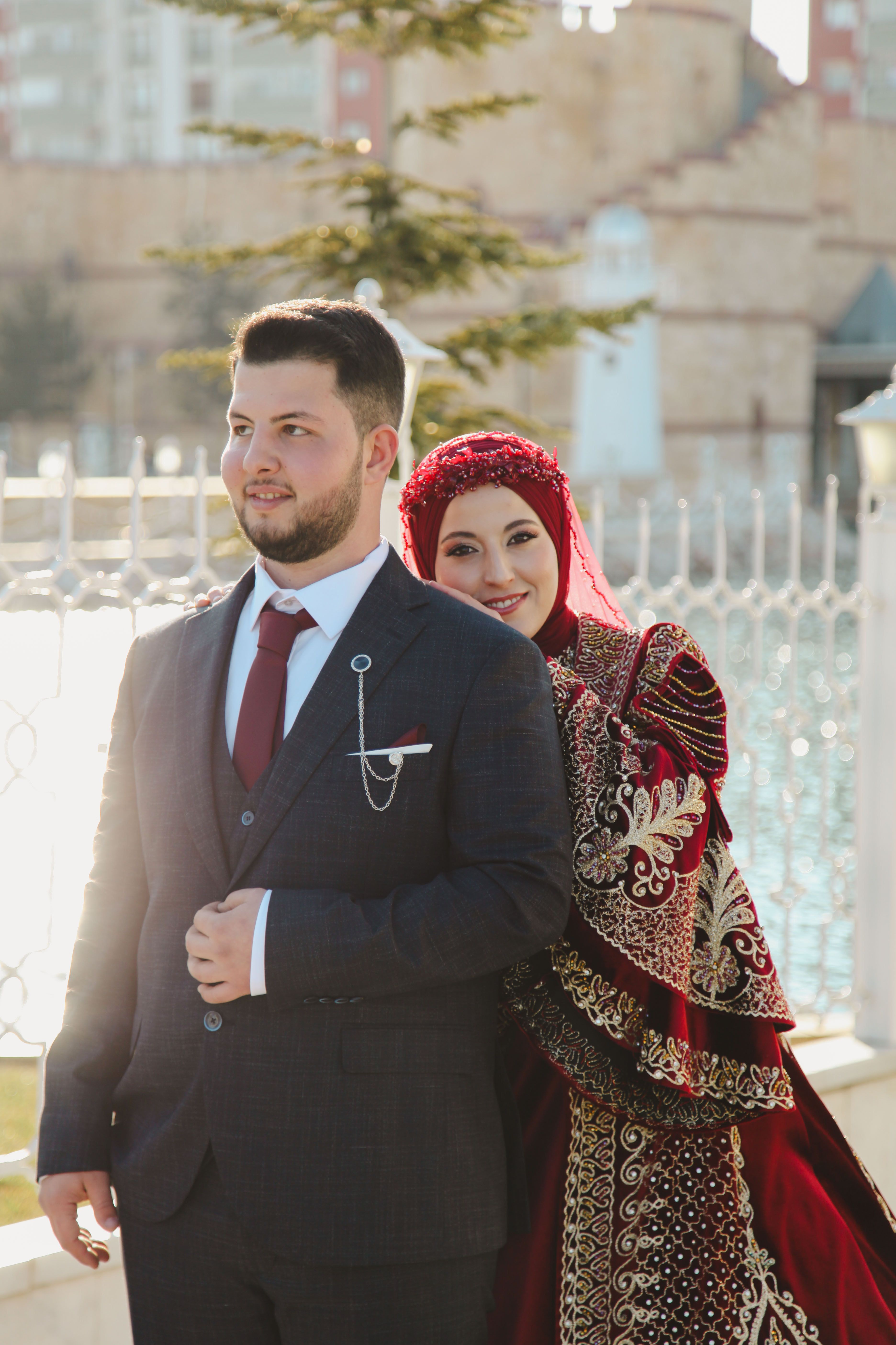 Traditional Wedding Couple in Elegant Attire Outdoors · Free Stock Photo