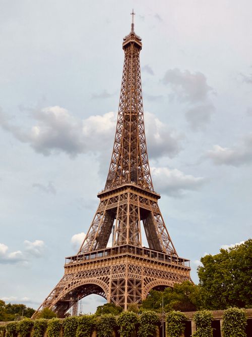 Free A classic view of the Eiffel Tower on a cloudy day, capturing the essence of Paris. Stock Photo