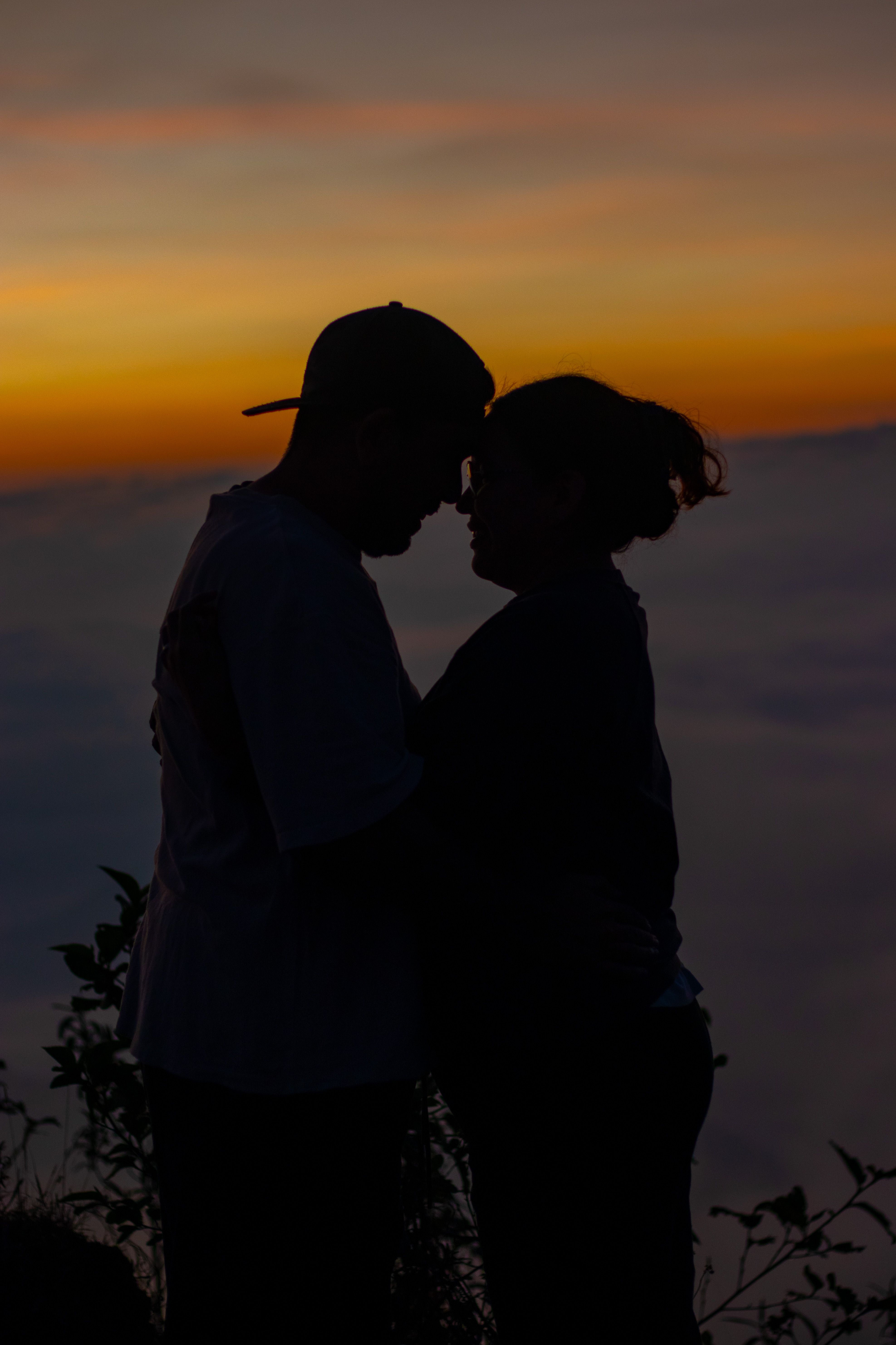 Silhouette of Couple Embracing at Sunset · Free Stock Photo