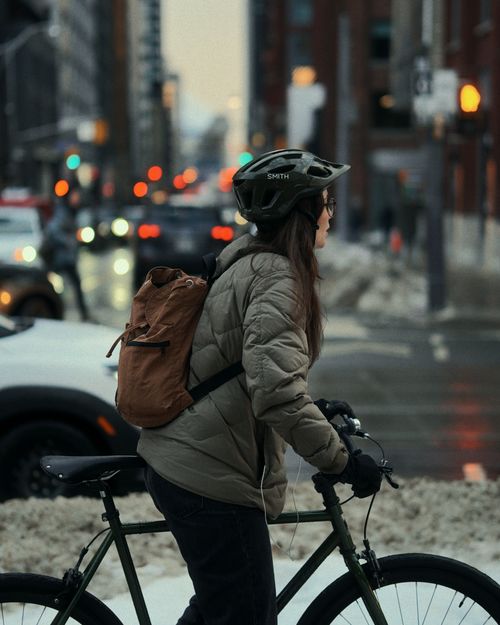 Free A cyclist rides through snowy streets during winter in Toronto, Canada. Stock Photo