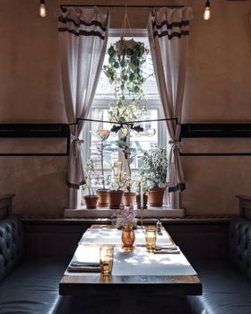 Inviting dining space with natural light through a window, perfect for a cozy meal.