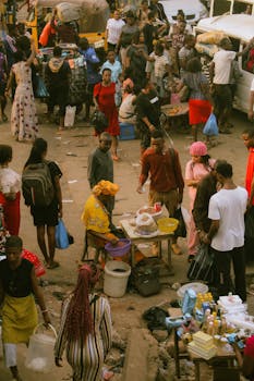 A bustling street market in Enugu, Nigeria, showcasing local vendors and shoppers.