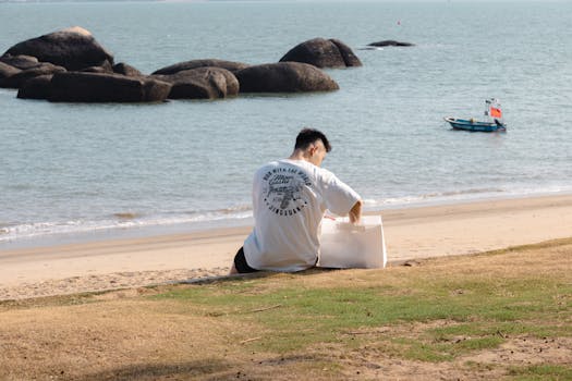 Man enjoying a peaceful day by the seaside in Xiamen, China with eco-friendly packaging.
