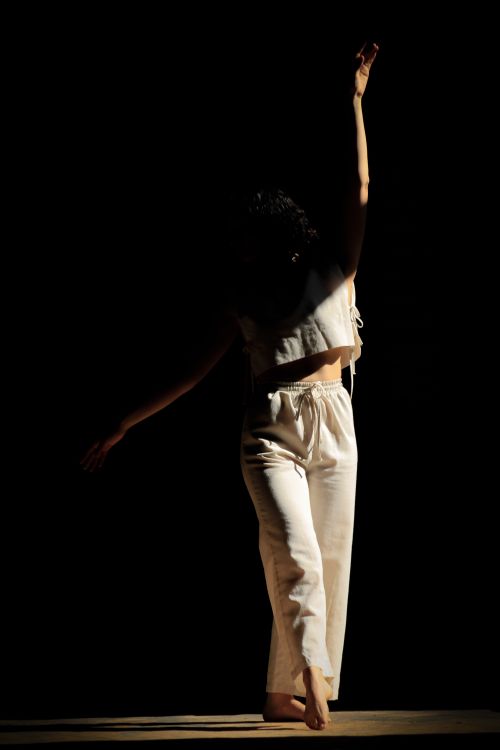 Free Silhouette of a dancer striking a graceful pose in dramatic lighting, showcasing elegance and motion. Stock Photo
