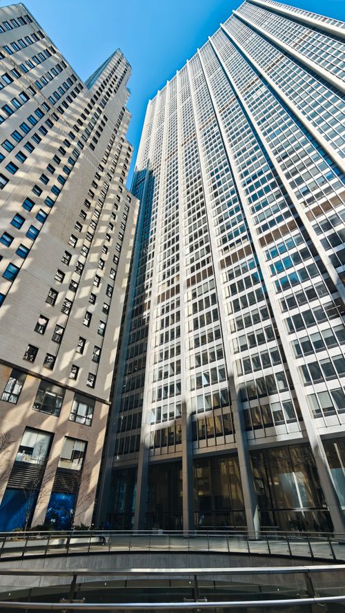 Free Upward view of modern skyscrapers in urban setting, showcasing architectural design. Stock Photo