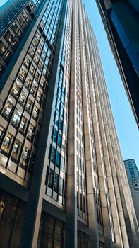 Towering skyscraper with a modern design under clear blue skies.