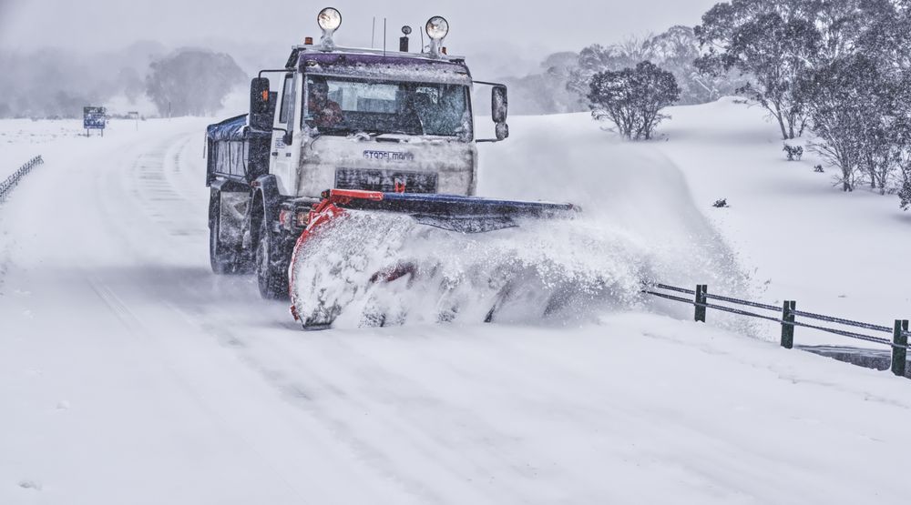 Heavy-duty plow clearing a commercial roadway