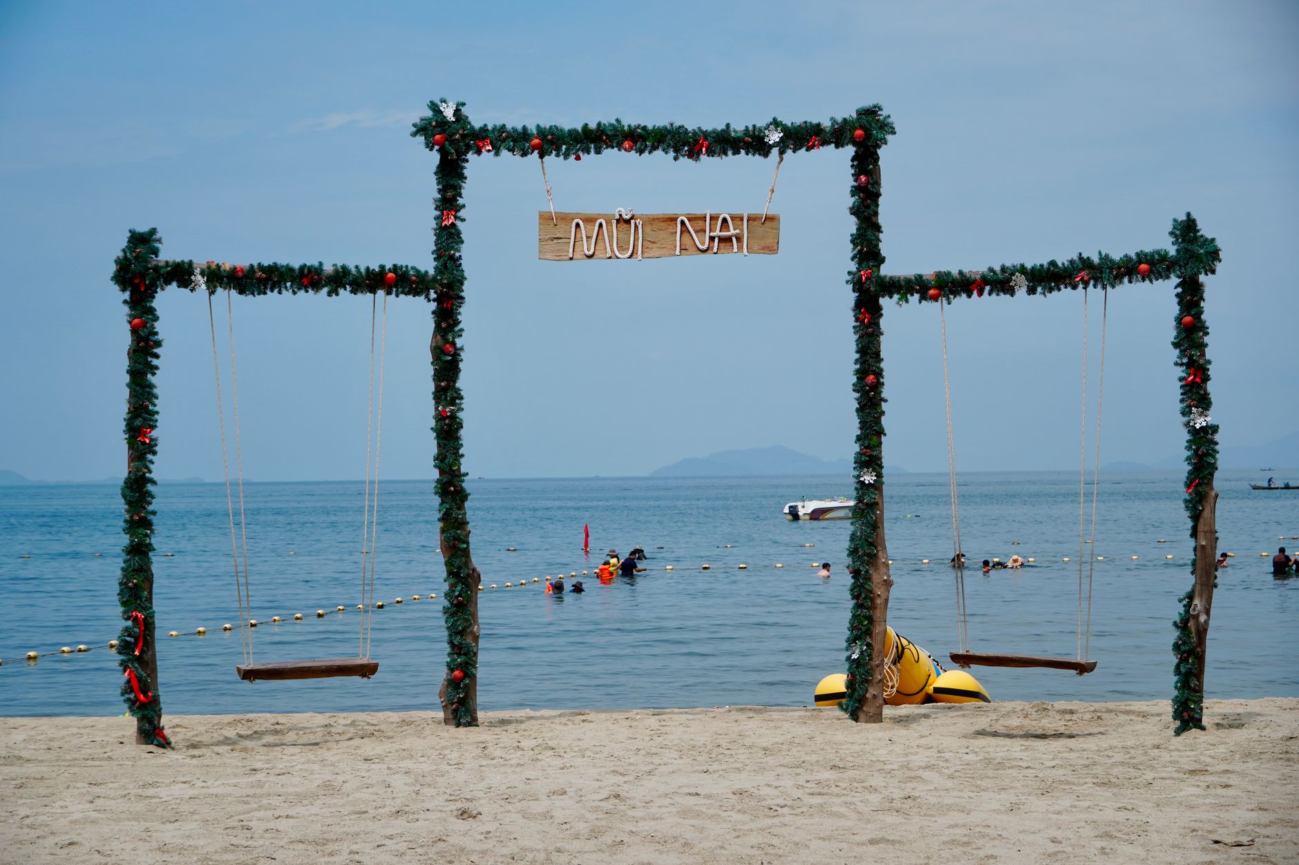 Decorated beach swings overlooking the ocean at Mui Nai, Vietnam, a perfect tropical getaway.