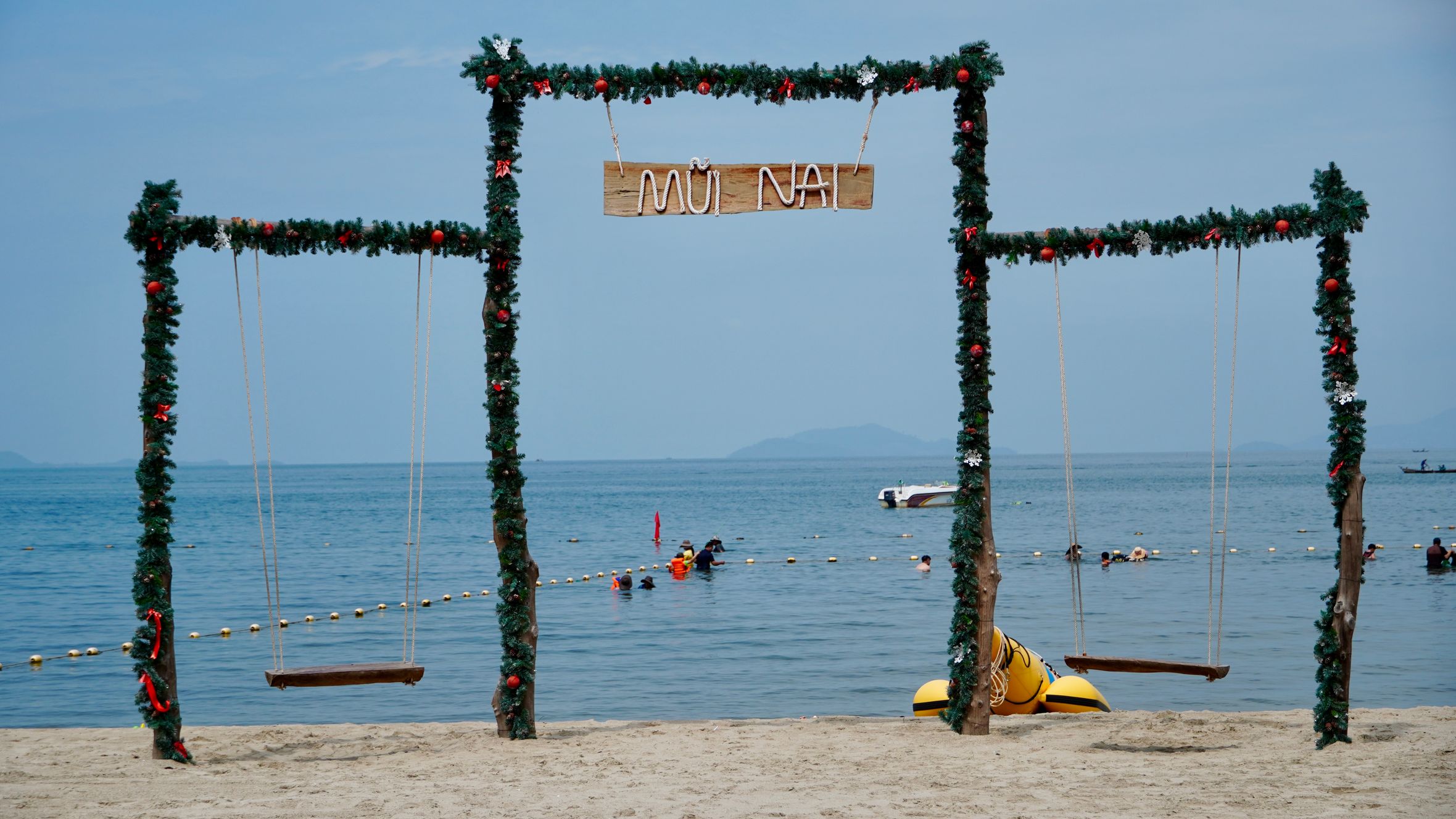 Decorated beach swings overlooking the ocean at Mui Nai, Vietnam, a perfect tropical getaway.
