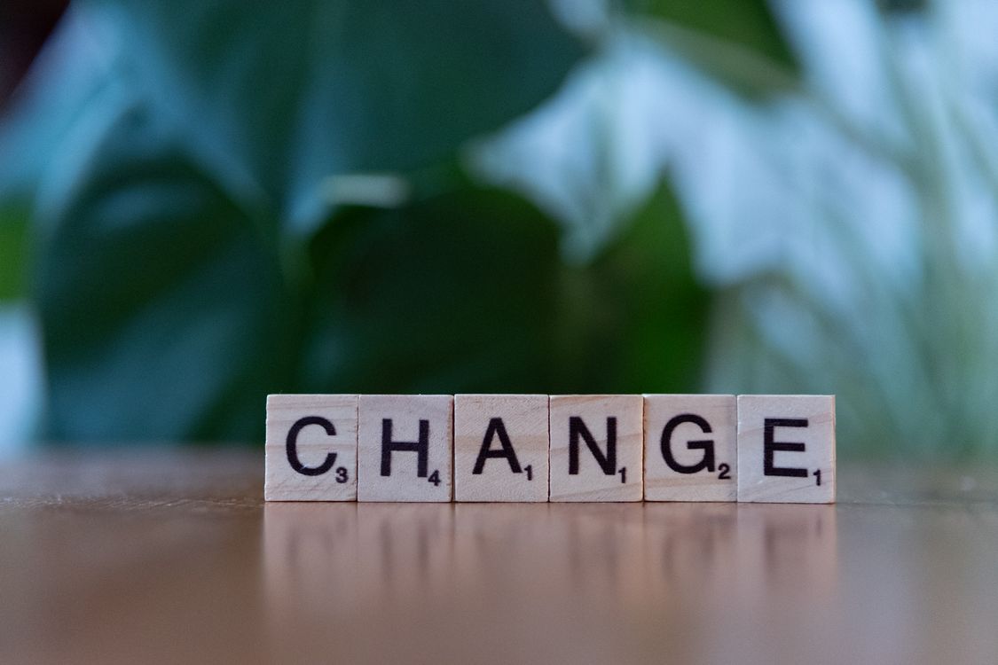 Transformation Scrabble Scrabble Letters Spelling Change on Wooden Surface · Free Stock Photo