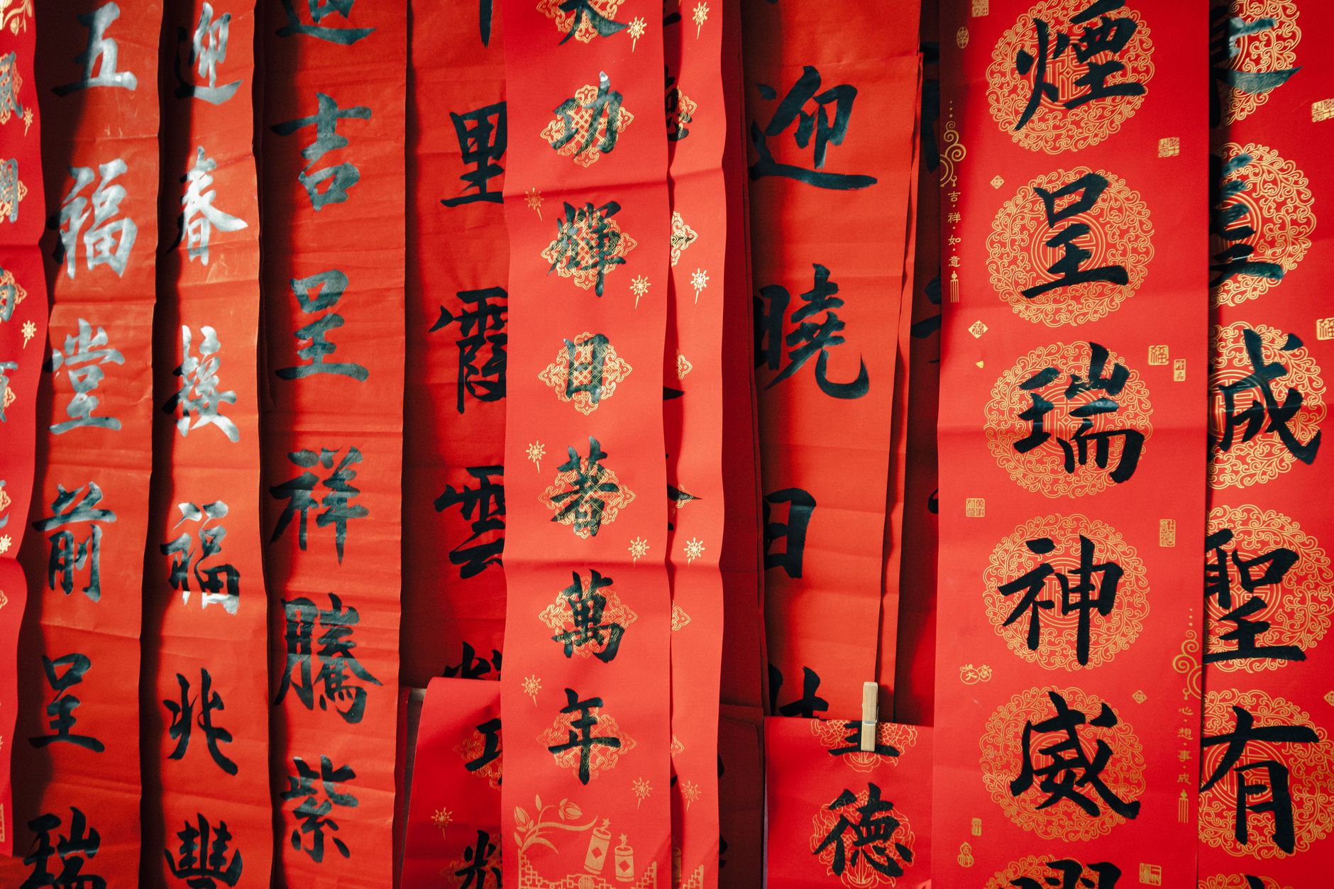Decorative red Chinese scrolls celebrating Lunar New Year with traditional calligraphy and symbols of good fortune.