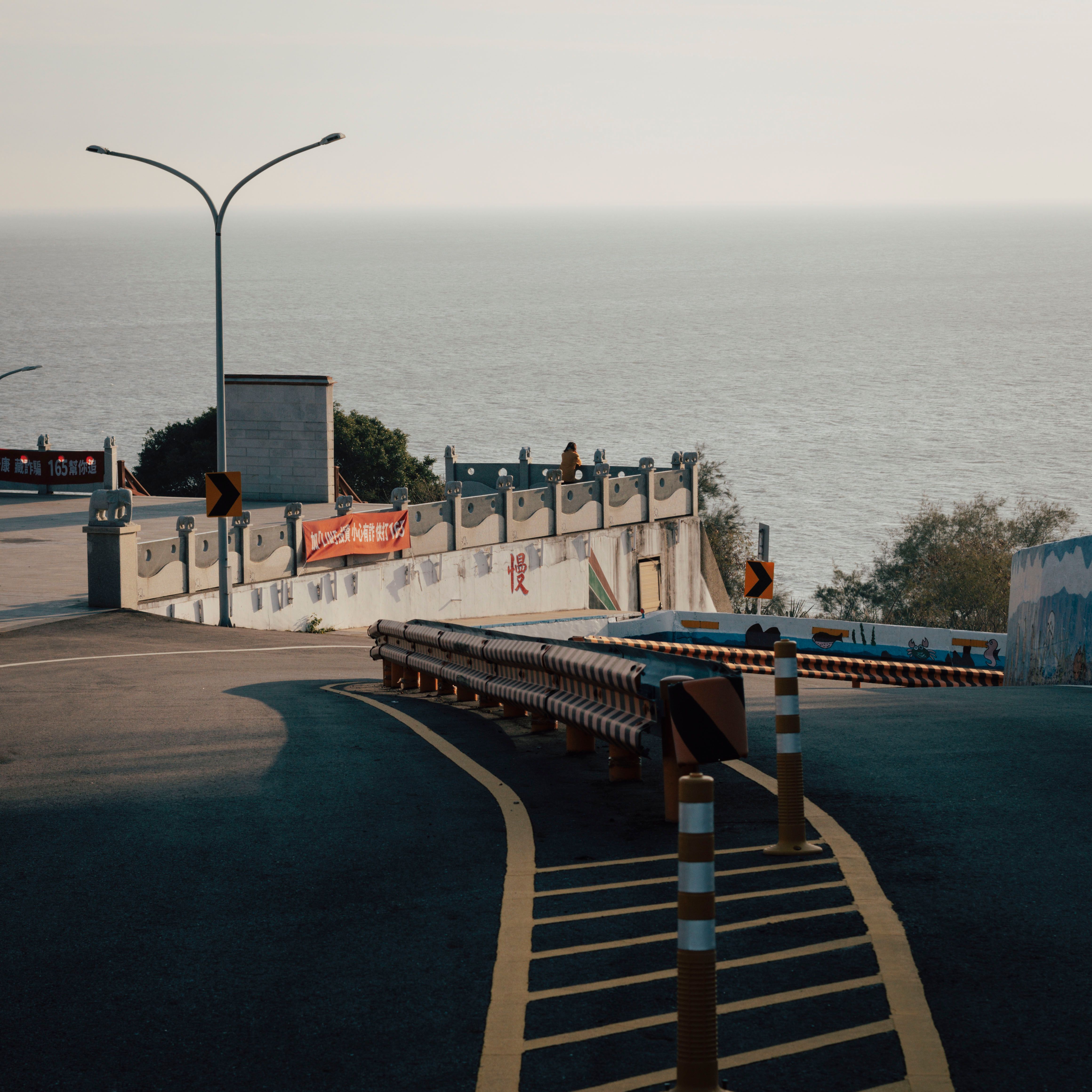 Scenic view of a curvy coastal road with ocean backdrop, ideal for travel themes.
