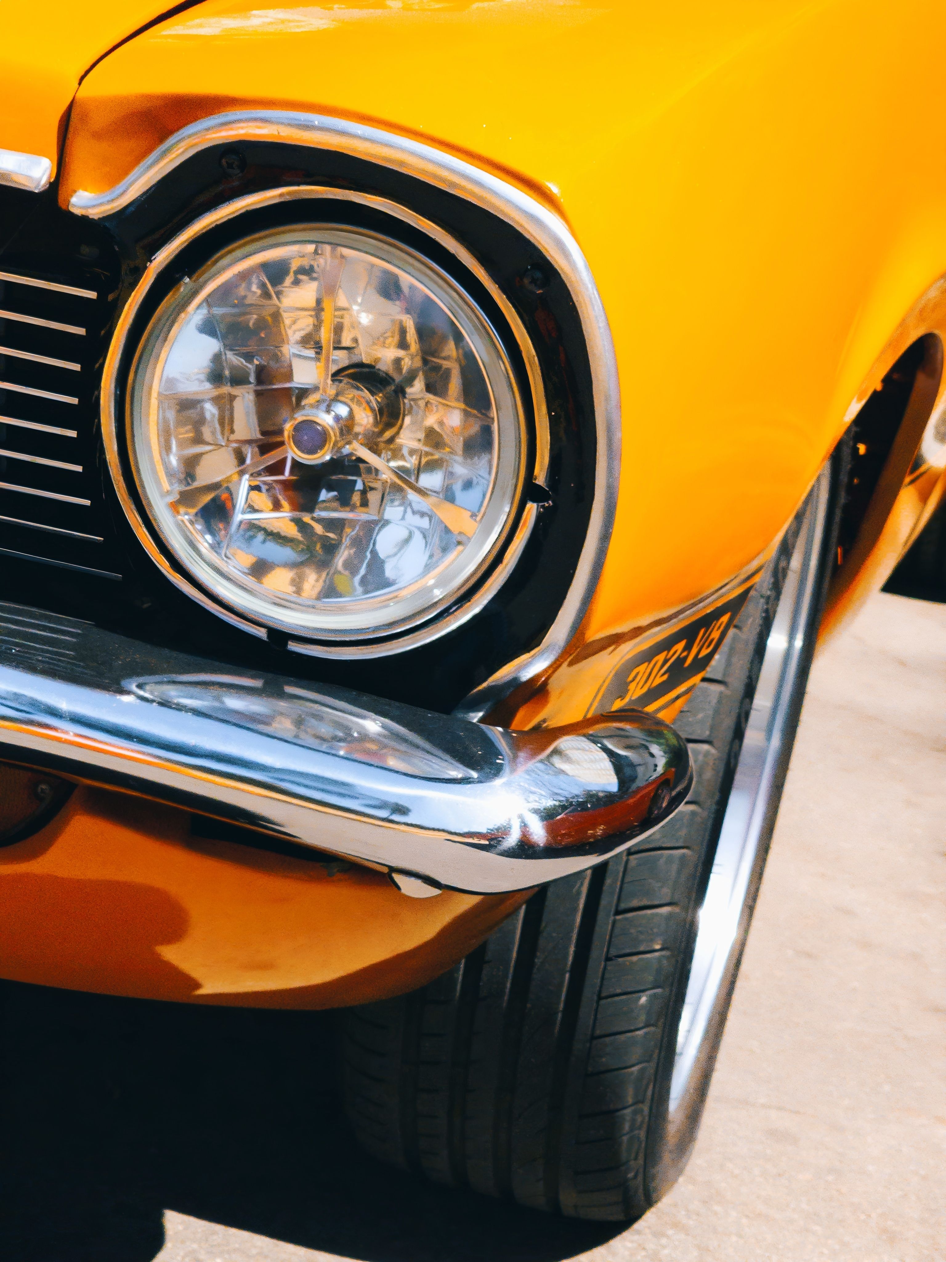 Vintage Yellow Car Headlight Close-Up in Sunlight · Free Stock Photo