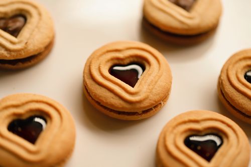 Free Delicious heart-shaped biscuits with jam. Perfect for sweet treats and baking themes. Stock Photo