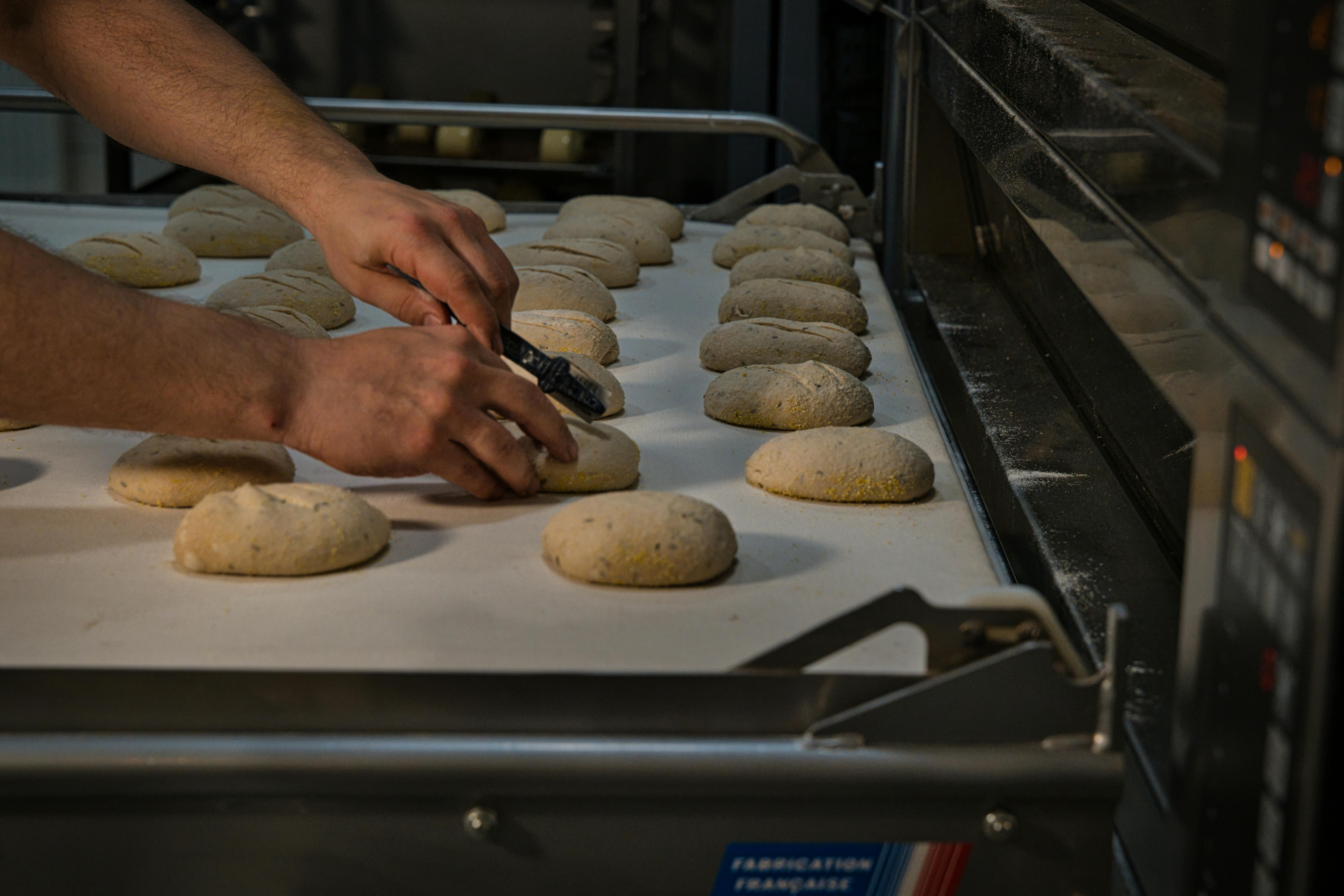 Close-up of dough preparation at an artisan bakery in Berlin, Germany, showcasing traditional bread making.