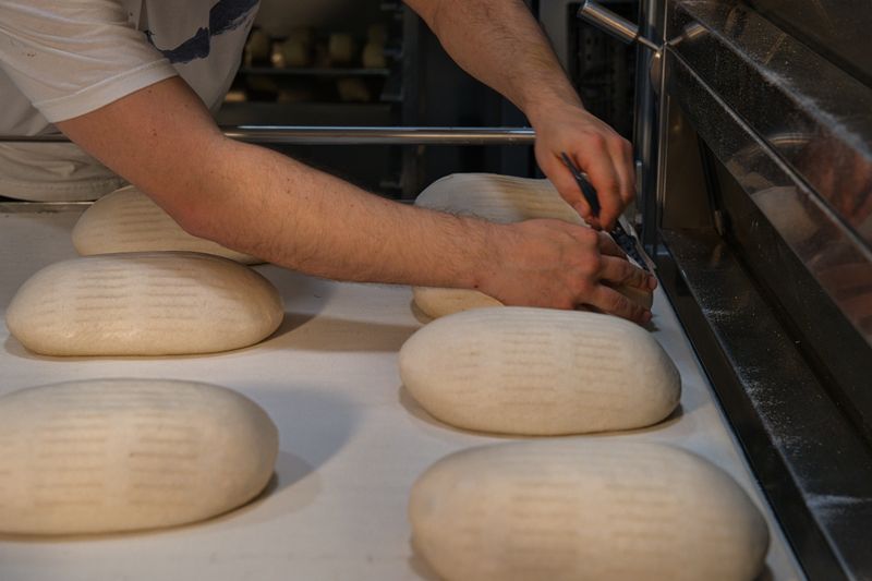 Baker shaping handmade sourdough at Best Bakery 2026 in Sydney, NSW