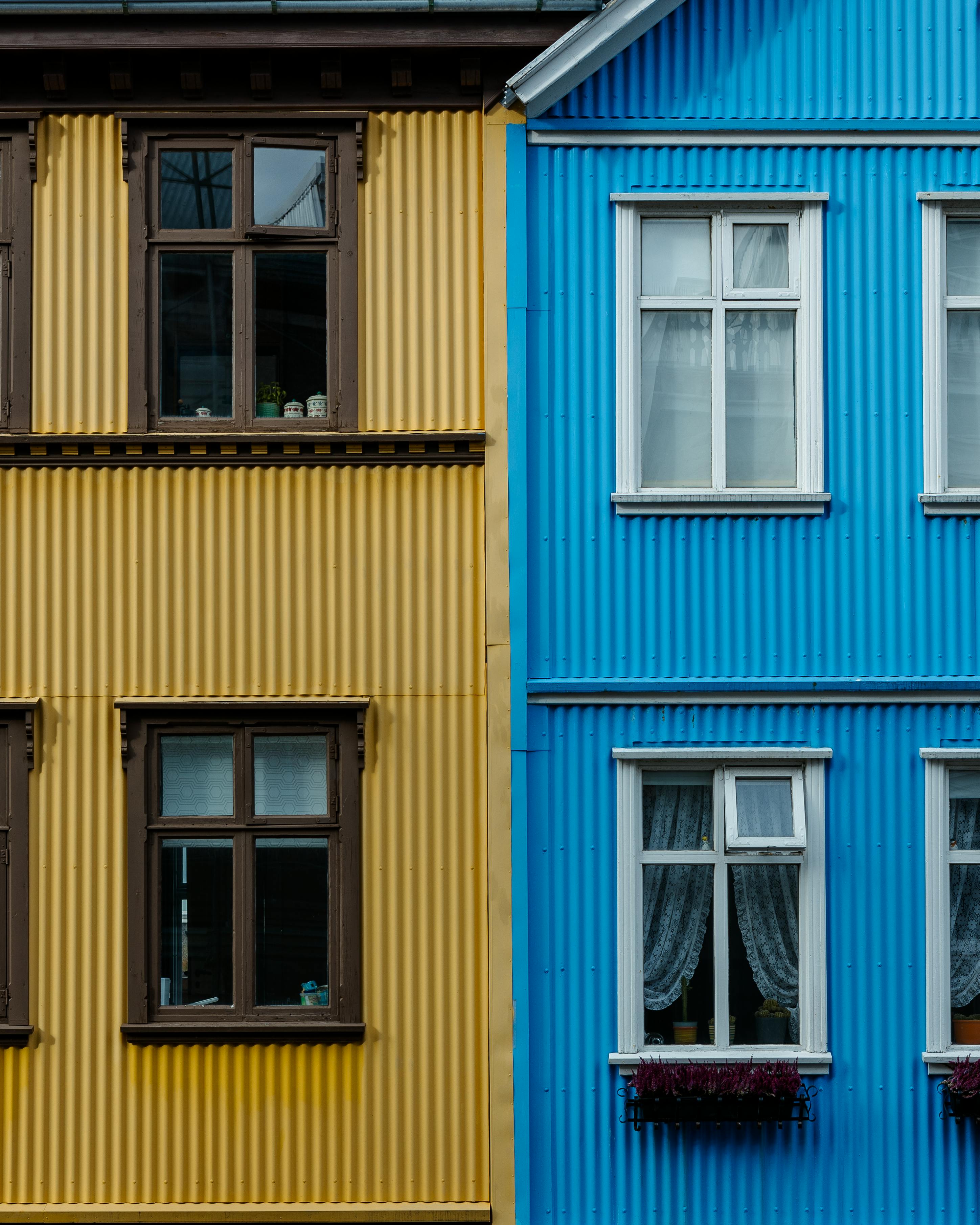 Vibrant blue and yellow apartment facade showcasing unique urban architecture.
