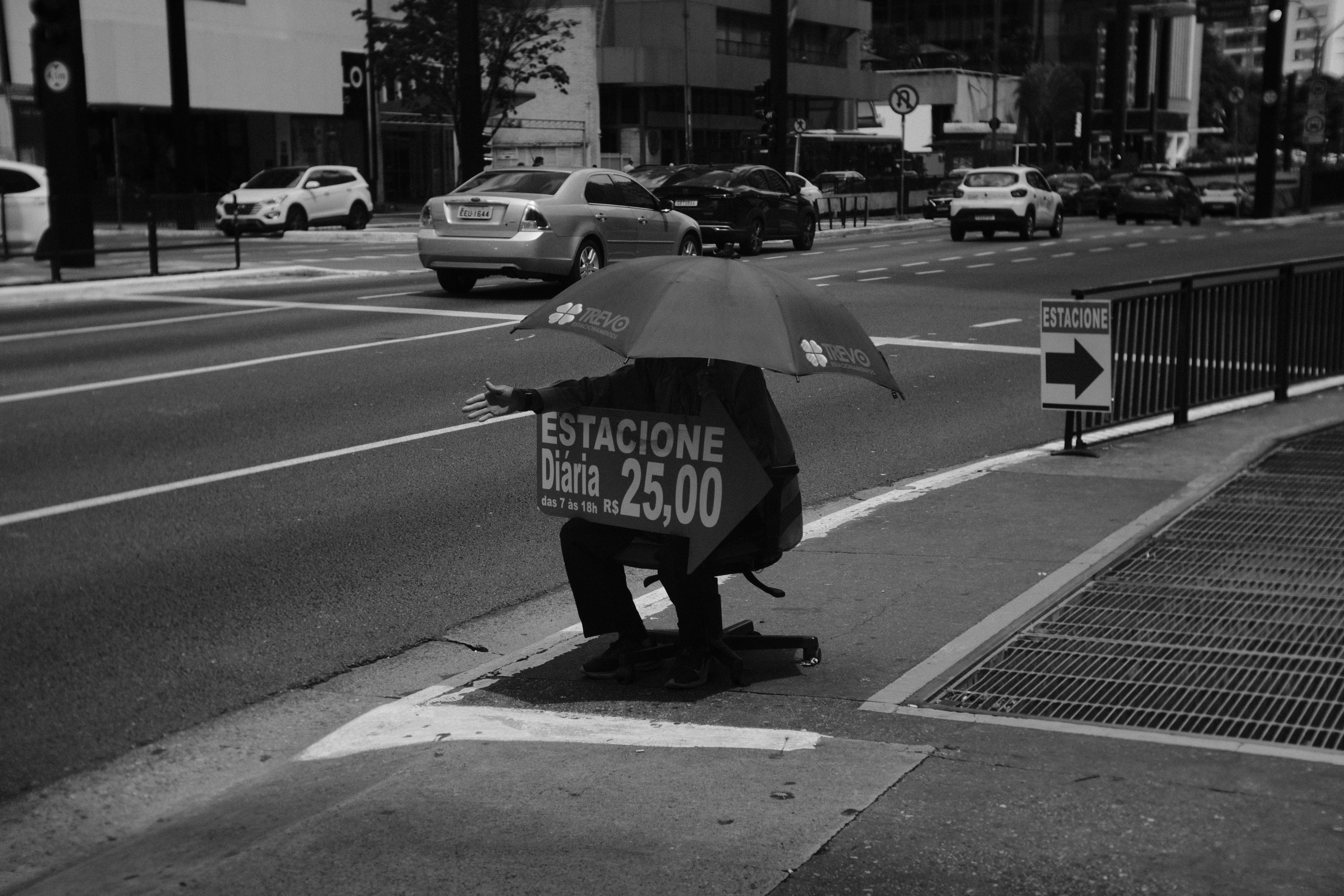 street scene with umbrella and sign in urban setting