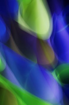 Vibrant and dynamic abstract light patterns in blue and green hues.