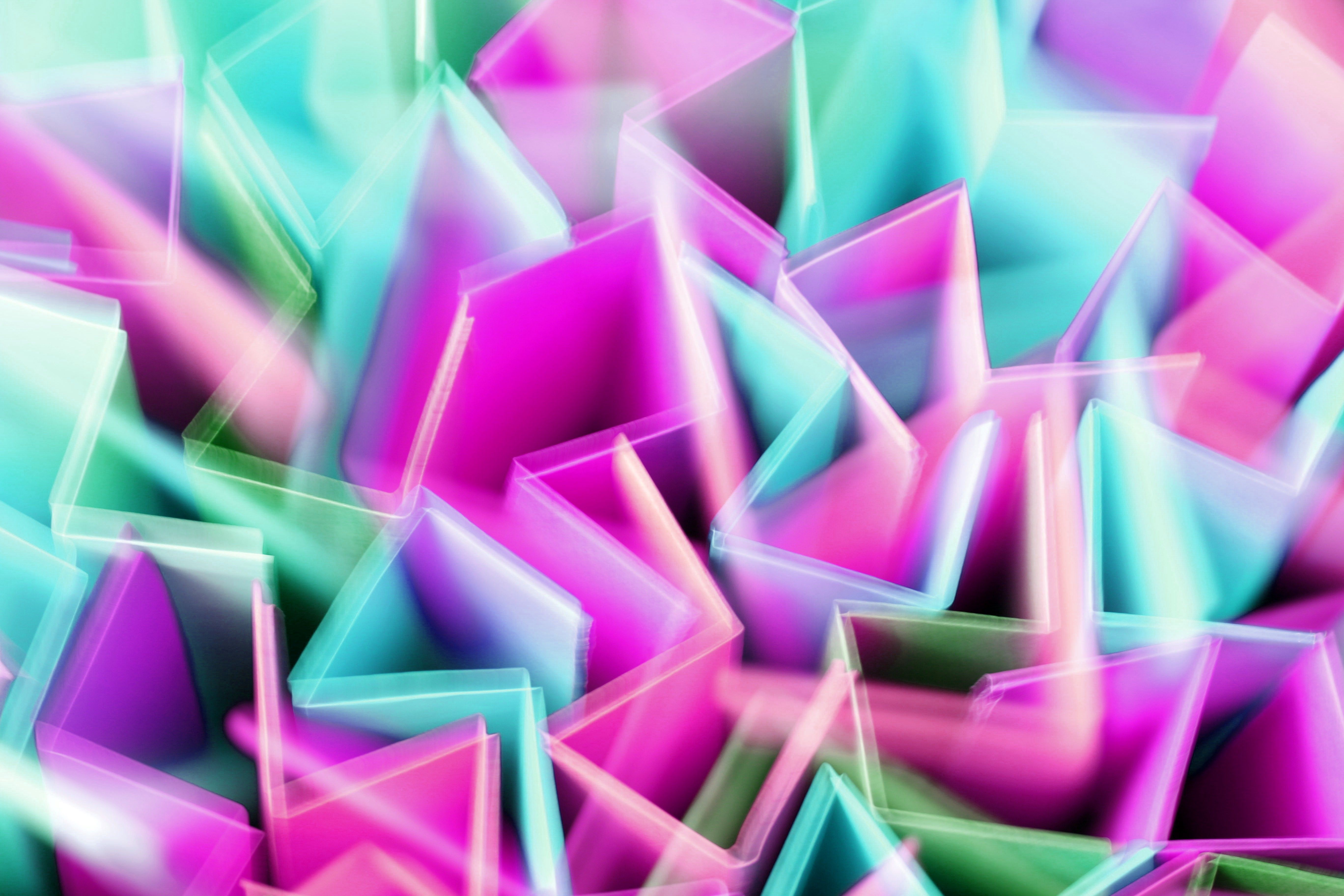 Vibrant abstract artwork featuring pastel geometric shapes in motion.