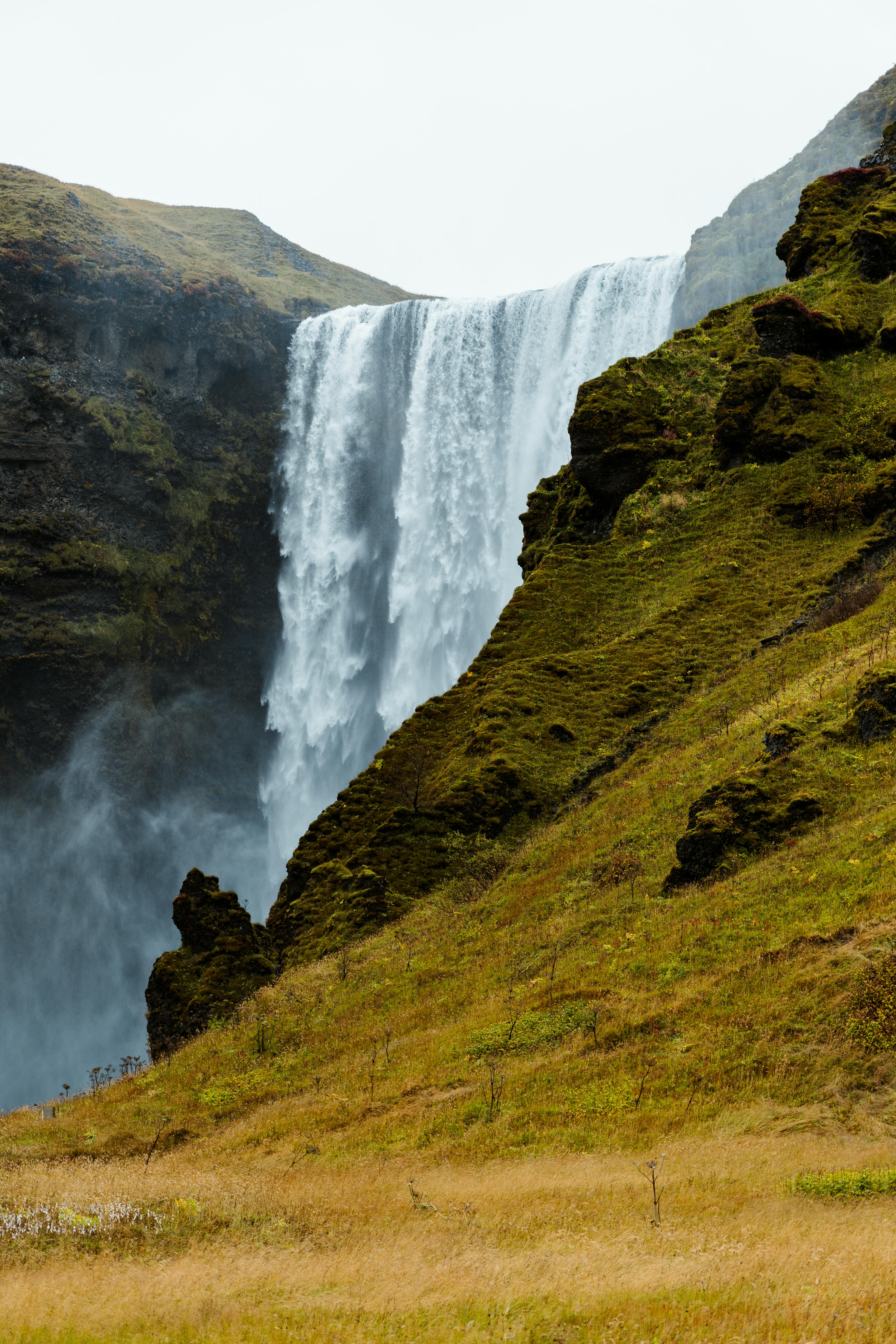 Breathtaking waterfall cascading over cliffs in Iceland's natural landscape.