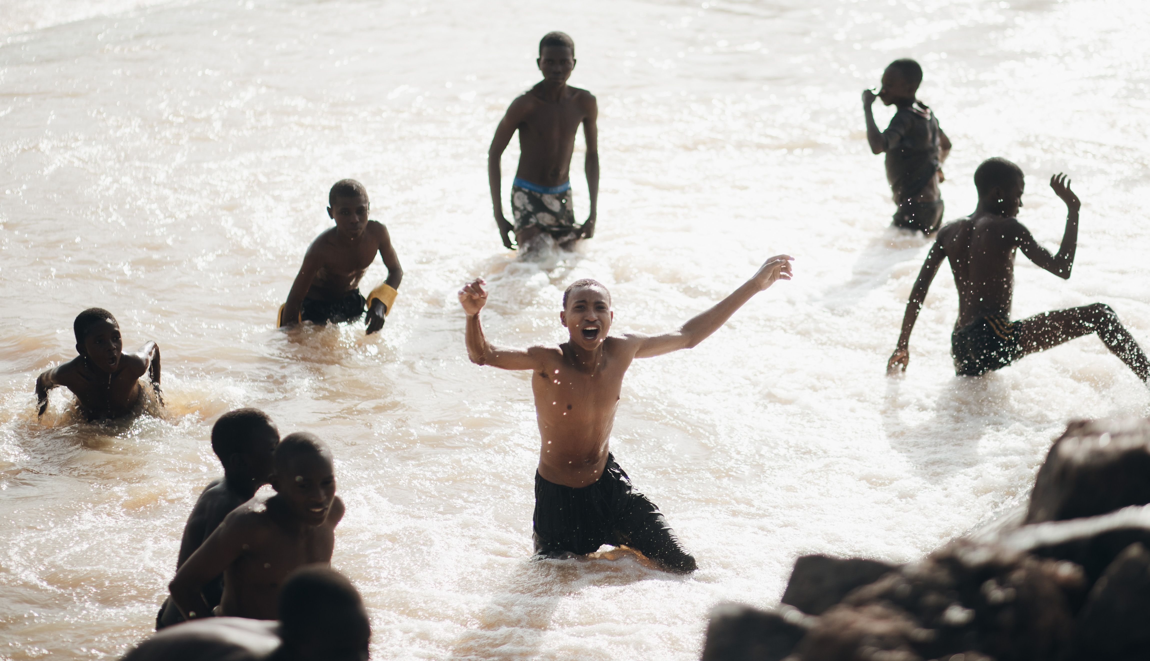 Joyful Children Playing in Ocean Waves · Free Stock Photo