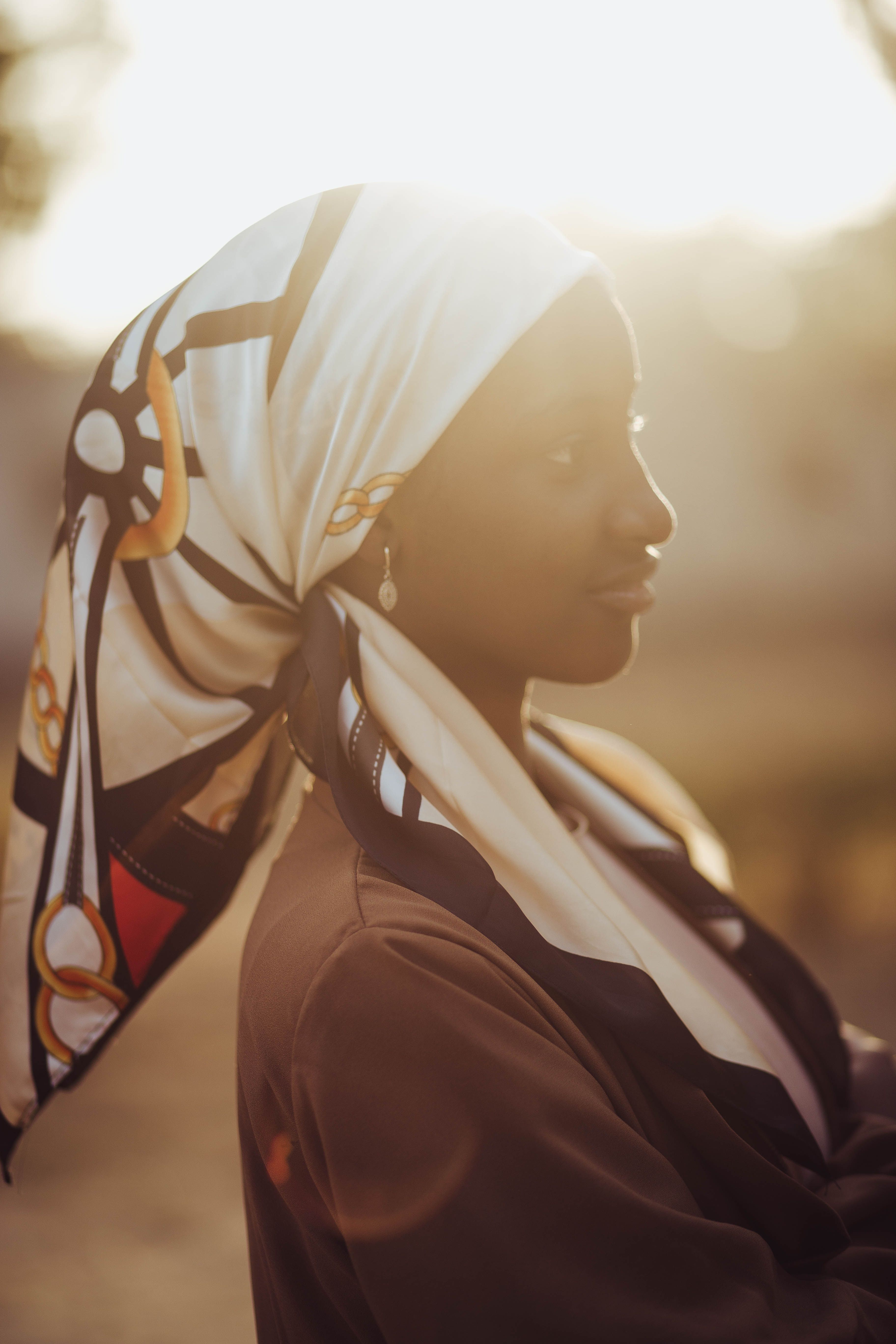Portrait of Woman in Sunlight with Patterned Headscarf · Free Stock Photo