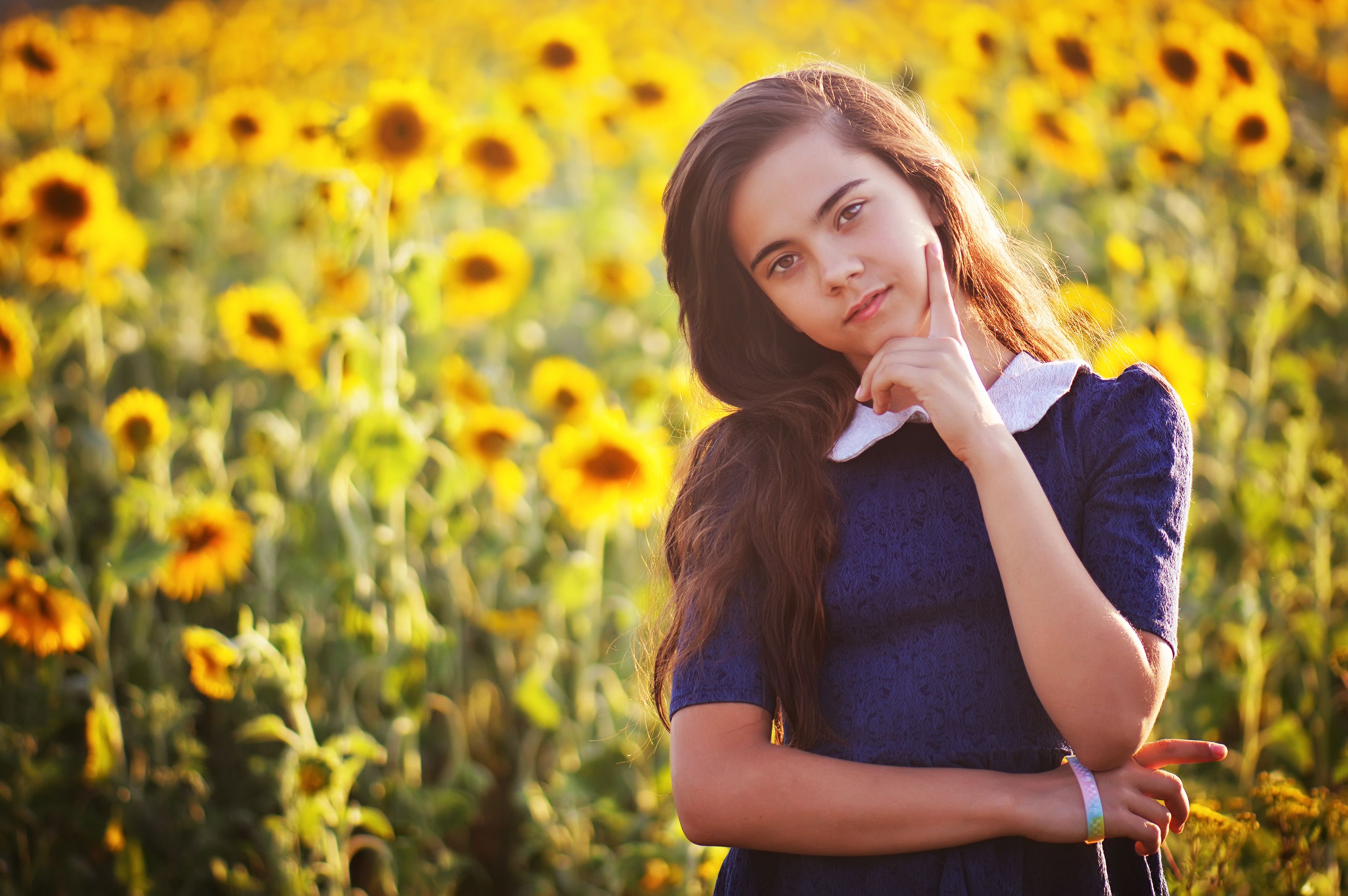 Thoughtful Girl in Sunflower Field at Sunset · Free Stock Photo
