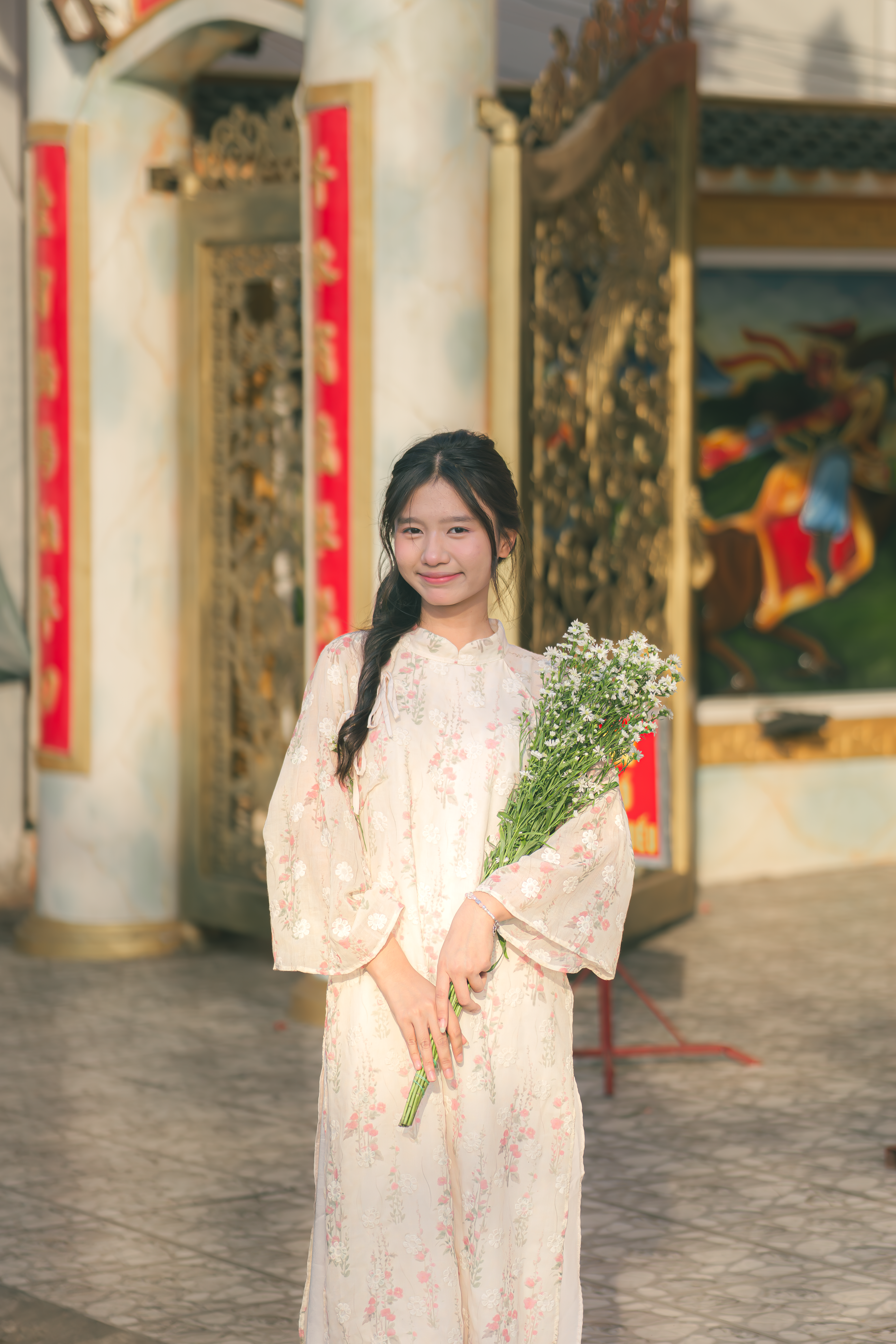 Young Woman in Traditional Dress Holding Flowers · Free Stock Photo