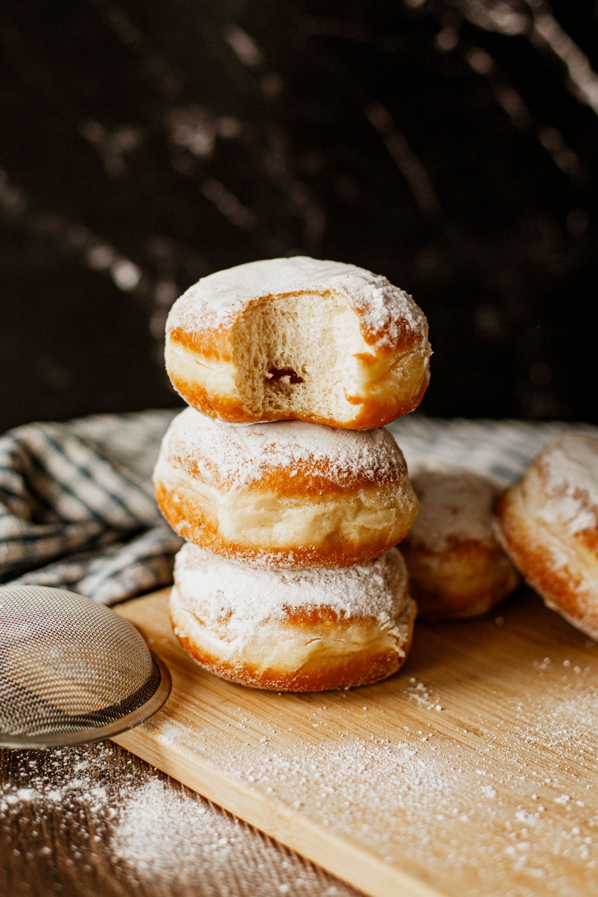Powdered sugar donuts arranged for a dessert display