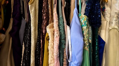 A vibrant collection of vintage dresses hanging on racks, showcasing diverse styles and fabrics.