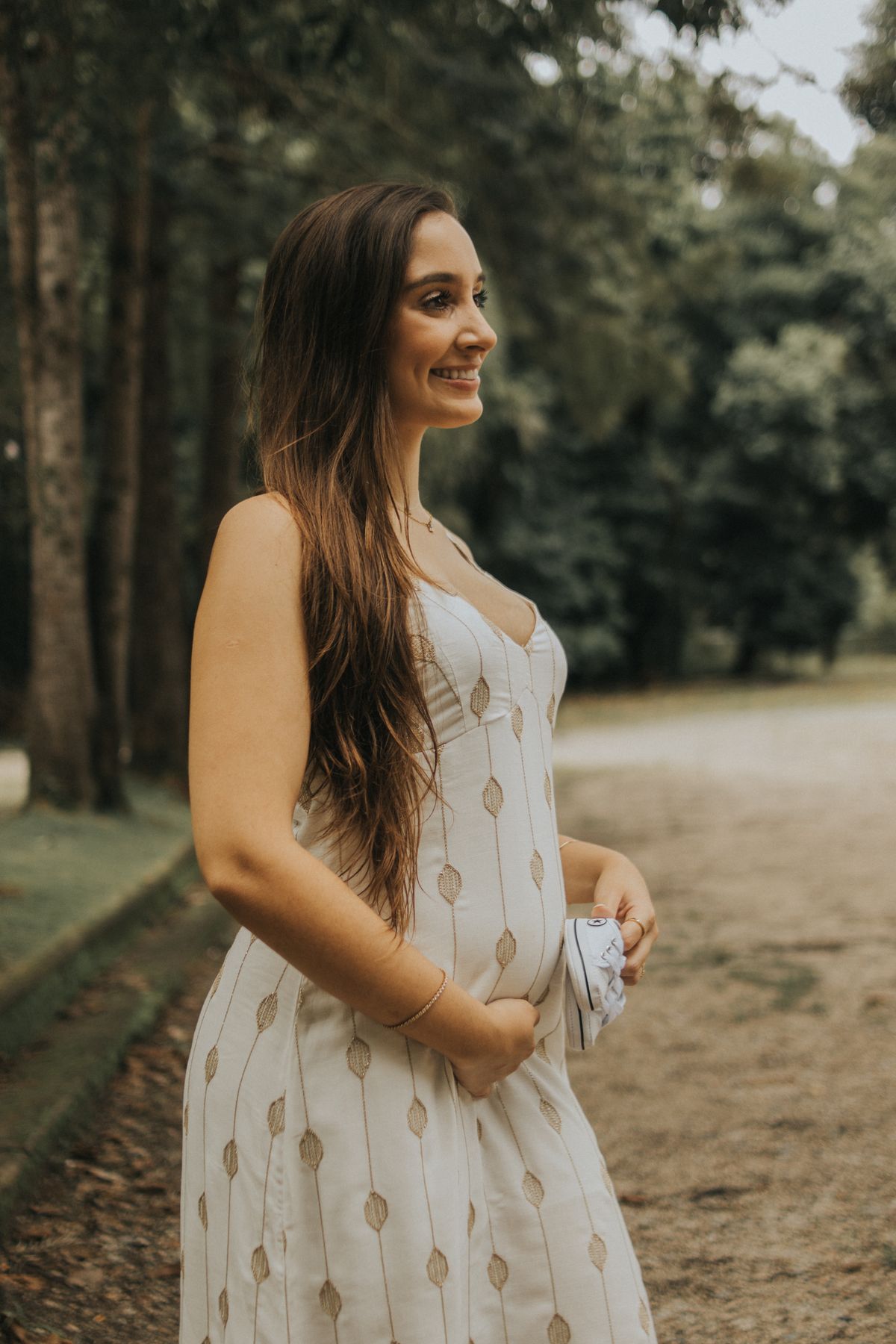 Pregnant woman walking peacefully through a park