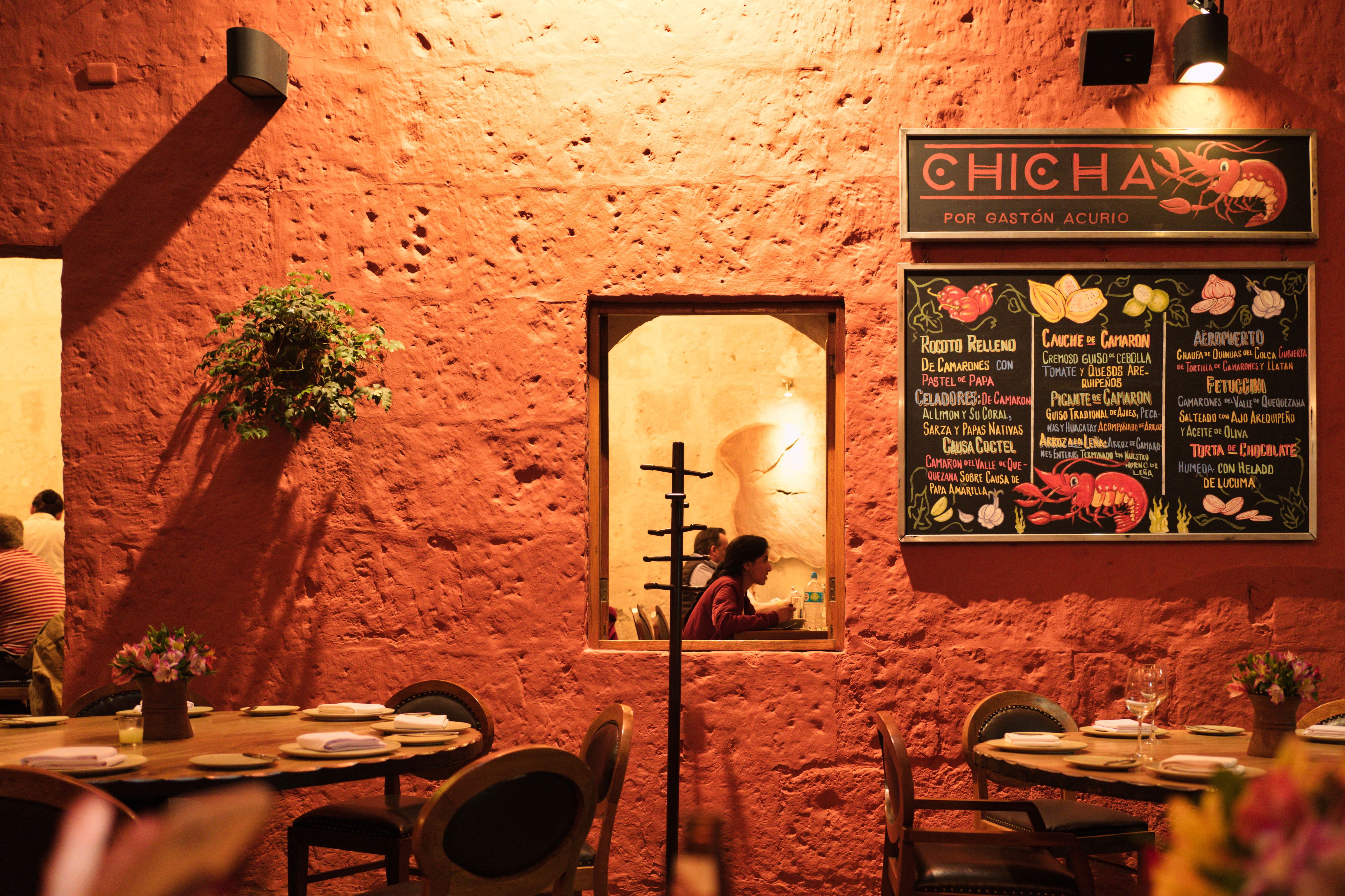 Warm interior of Chicha restaurant in Cusco, featuring traditional decor and ambiance.