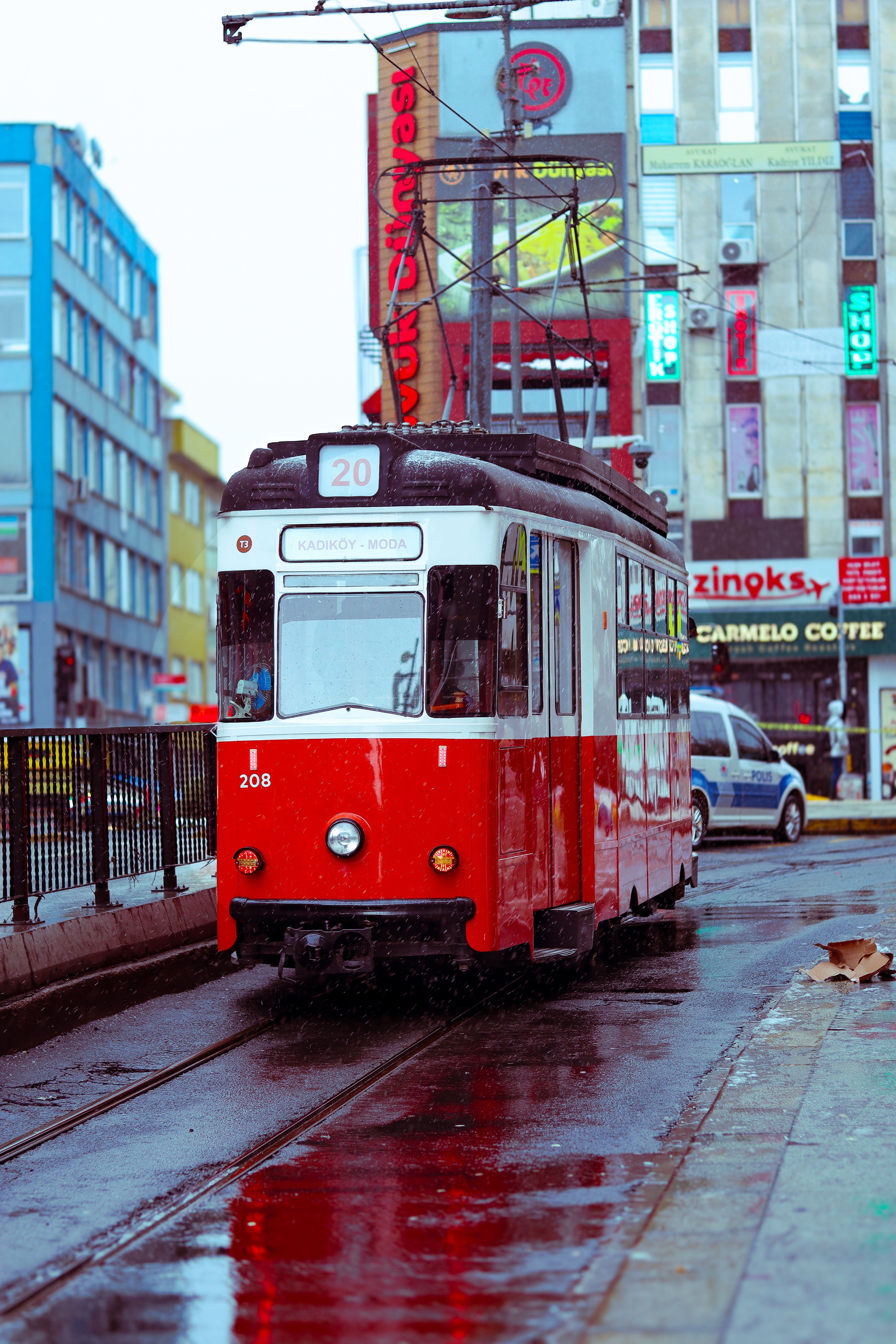Vintage Red Tram on Wet Urban Street · Free Stock Photo