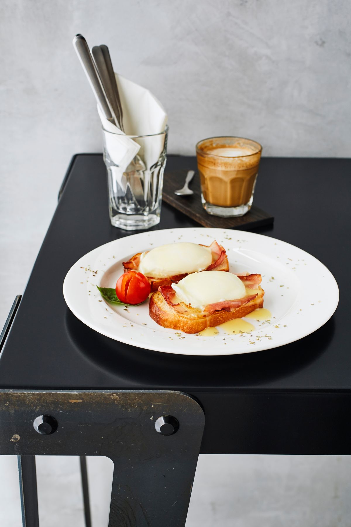 Eggs Benedict and coffee served on a restaurant table