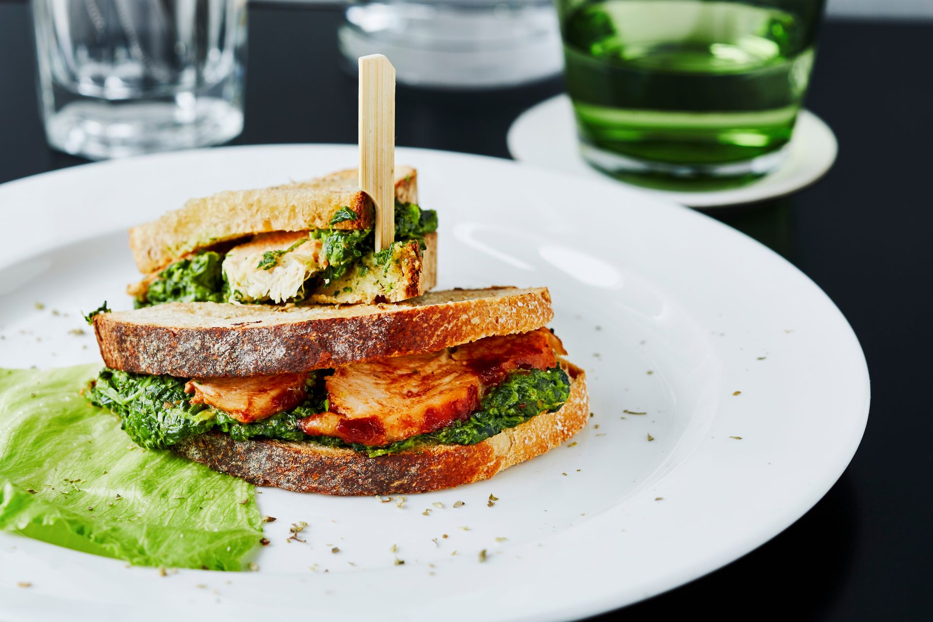 Close-up of chicken and spinach sandwich on restaurant table