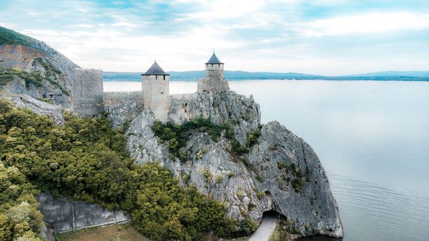 Stunning aerial image of Golubac Fortress against the Danube River, highlighting ancient architecture and natural beauty.