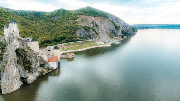 A breathtaking aerial shot of Golubac Fortress overlooking the Danube River in Serbia. Perfect for travel and history enthusiasts.
