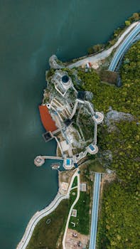 Stunning aerial view of Golubac Fortress and winding roads along the Danube River in Serbia.