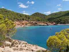 Sunset over a Balearic cove with whitewashed buildings