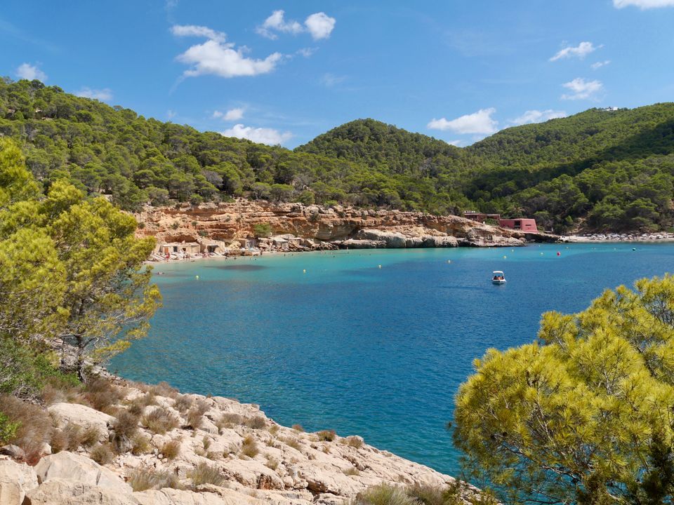 Sunset over a Balearic cove with whitewashed buildings