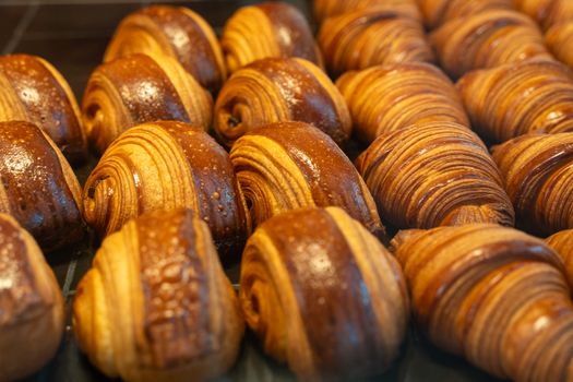 Delicious freshly baked chocolate croissants on display in a Berlin bakery, perfect for breakfast.