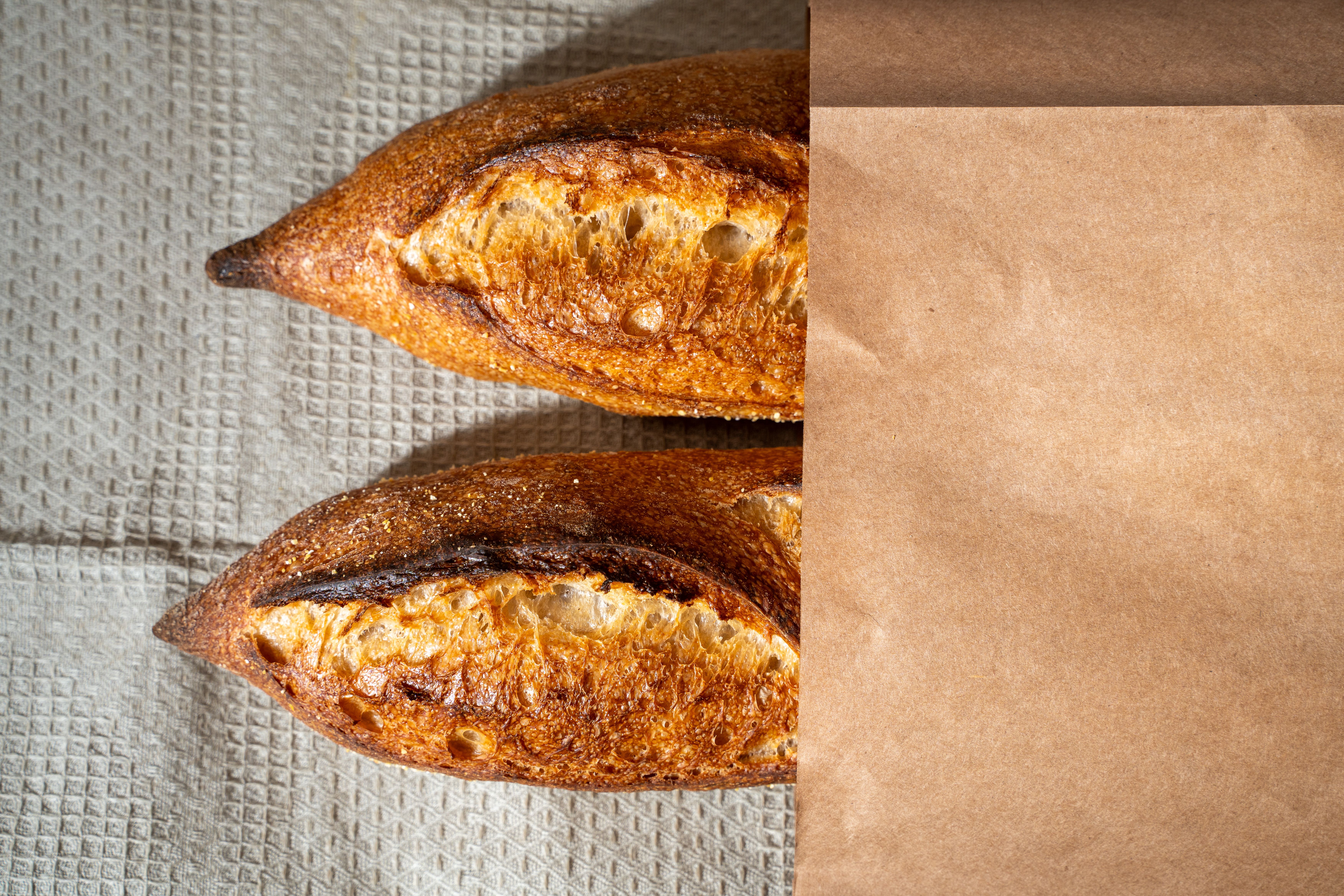 Freshly Baked Artisan Baguettes in Paper Bag · Free Stock Photo
