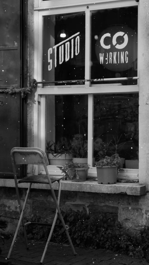 Free Cozy studio coworking space seen from outside window in snowy winter setting. Stock Photo