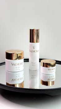 Elegant display of Valmont's V-Lift skincare products on a mirrored surface.