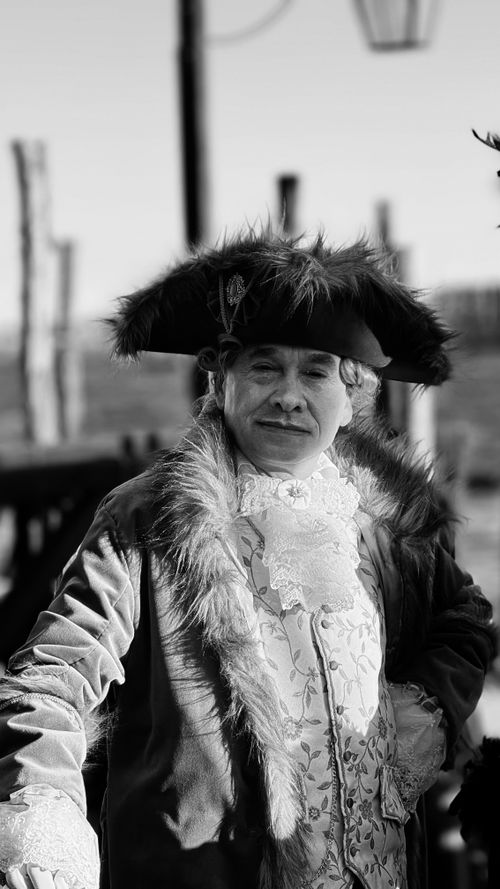 Free Black and white portrait of a man in historical attire outdoors. Stock Photo